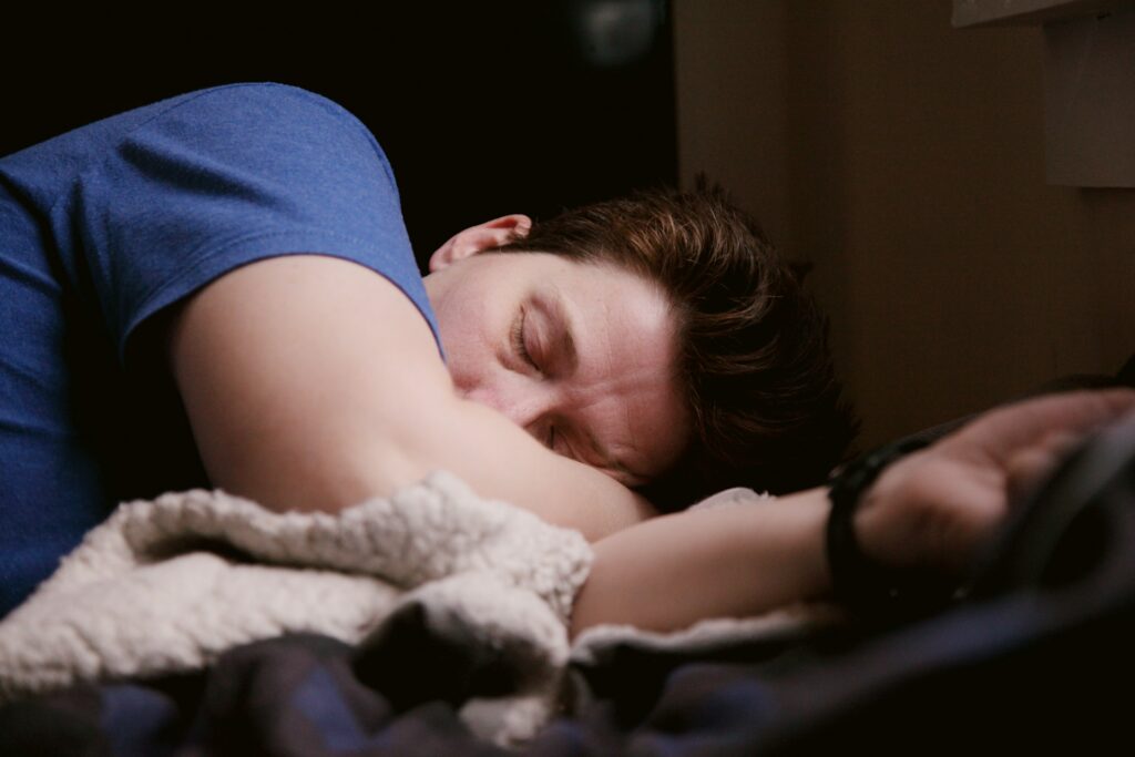 A man in a blue shirt napping
