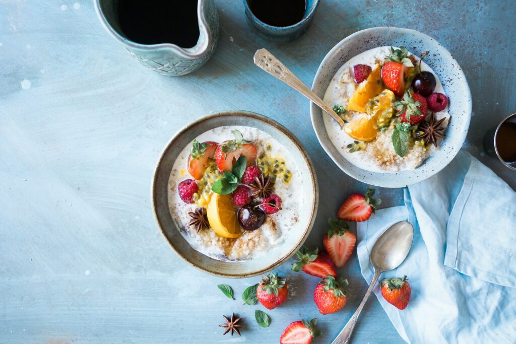 Two bowls of oatmeal with fruit