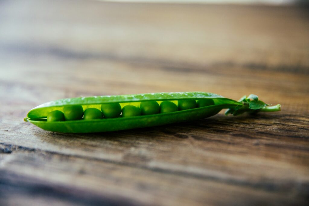 Sugar peas on a wooden table