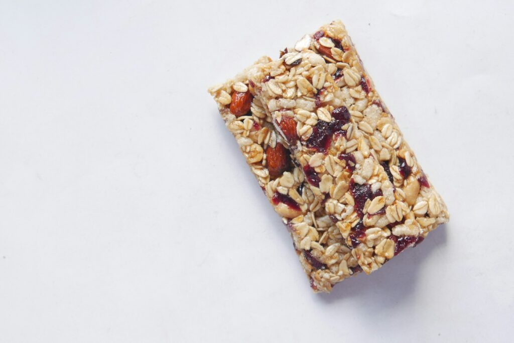 Two granola bars stacked on a white table