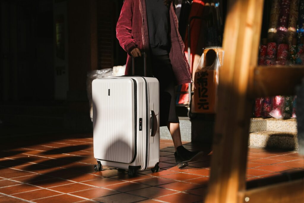 A white rolling suitcase