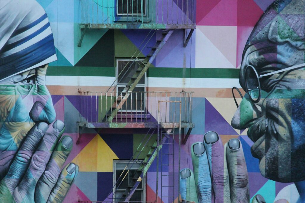A street art mural of Gandhi and Mother Theresa