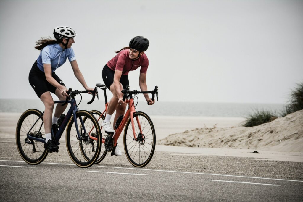 Two women cycling down a road