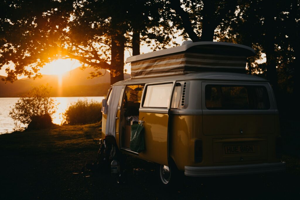 A classic van parked by a lake