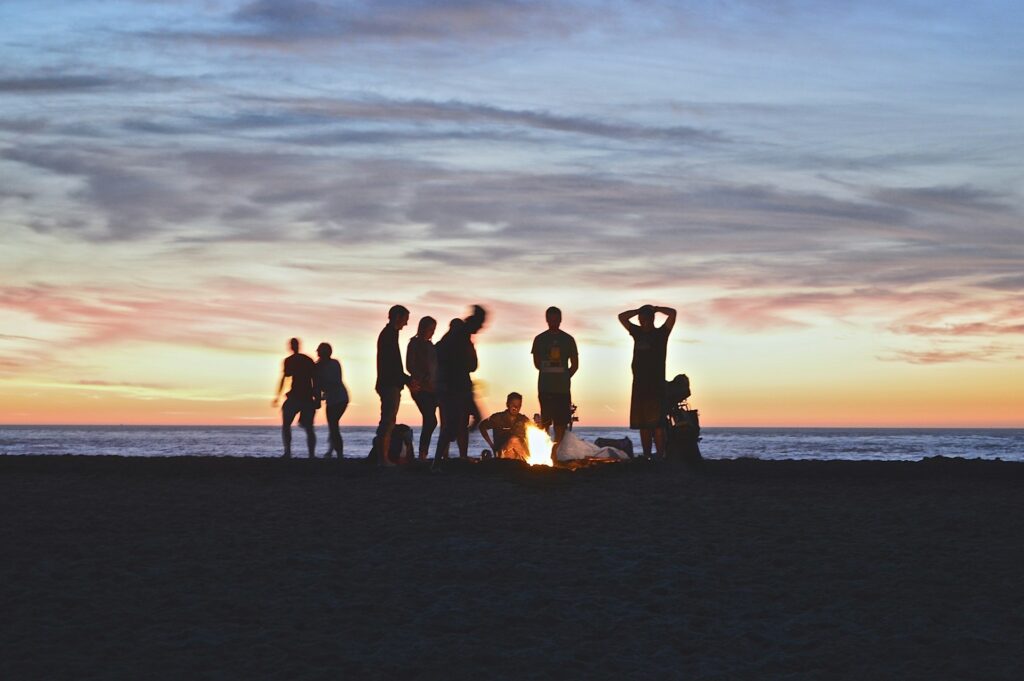 A group of friends enjoying a campfire on a beach