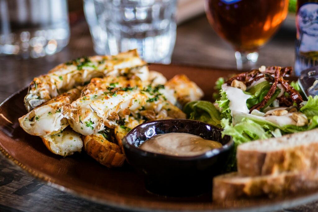 A plate of fish with salad and bread