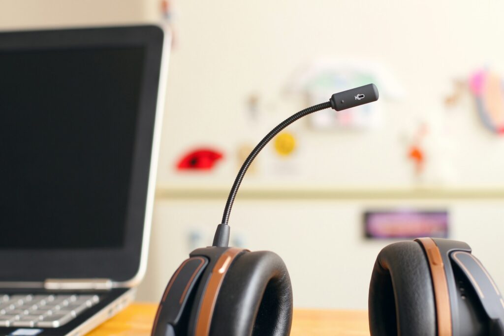 A customer service headset next to a laptop