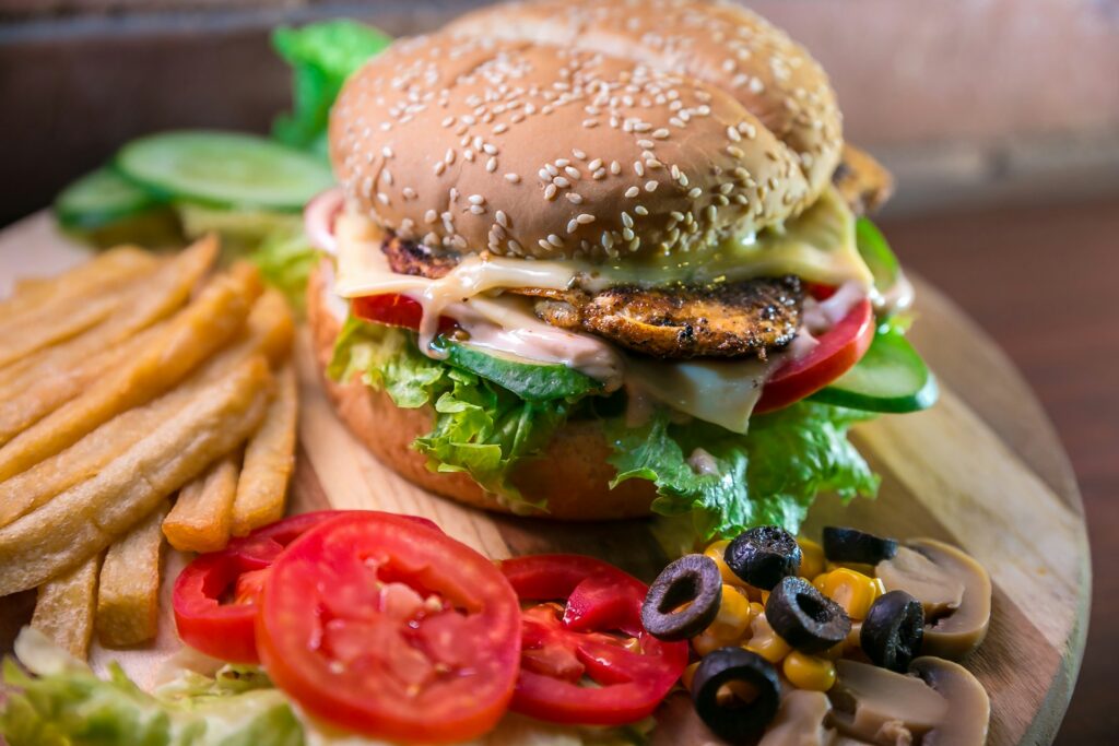 Burger and fries with salad and vegetables