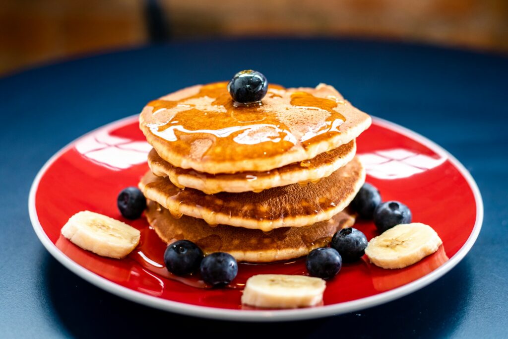 baked pancake with blueberry and slice of banana
