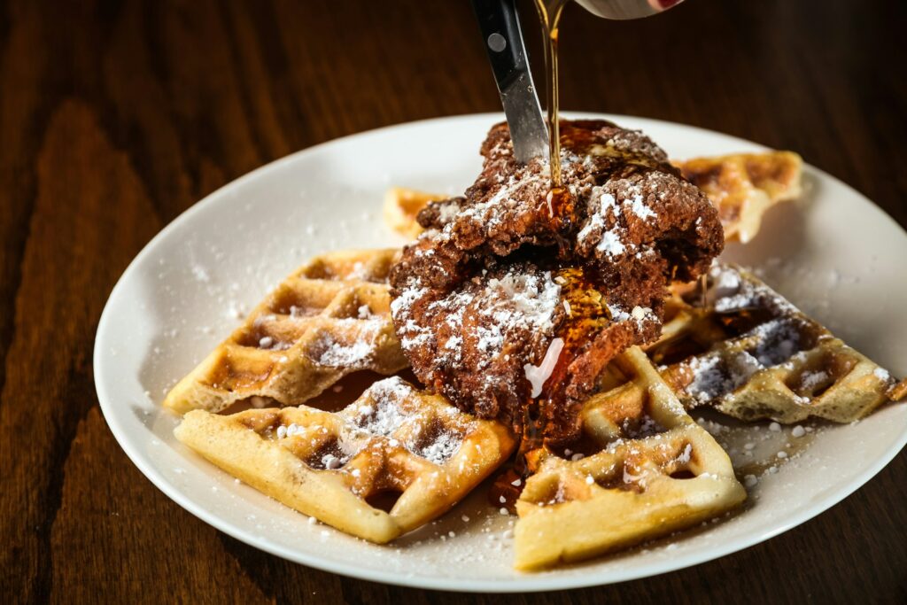 waffles with chocolate syrup on white ceramic plate
