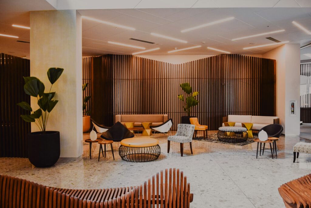 A lounge with stylish tables, seating, and plants for decoration.