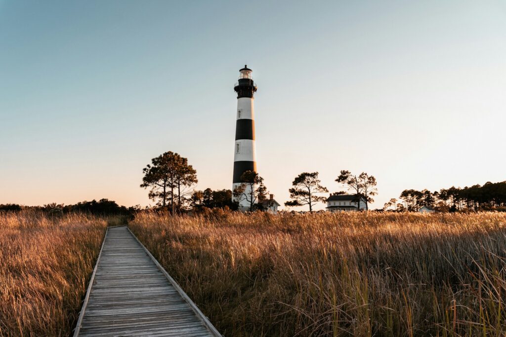 A grassy bank with a lighthouse